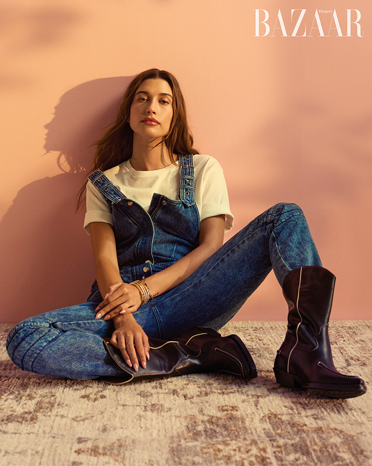 오버올은 Isabel Marant. 티셔츠는 Khaite. 뱅글은 Tiffany & Co.. 부츠는 Chloé. 니아신아마이드와 히알루론산이 피부를 촉촉하게 유지시켜준다. 헤일리가 사용한 ‘펩타이드 글레이징 플루이드’는 Rhode. 헤어/ Evanie Frausto for Redken 메이크업/ Raisa Flowers for M.A.C 매니큐어/ Gina Edwards for Dior Vernis 프로덕션/ Eric Jacobson at Hen’s Tooth Productions 세트 디자인/ Jesse Kaufmann