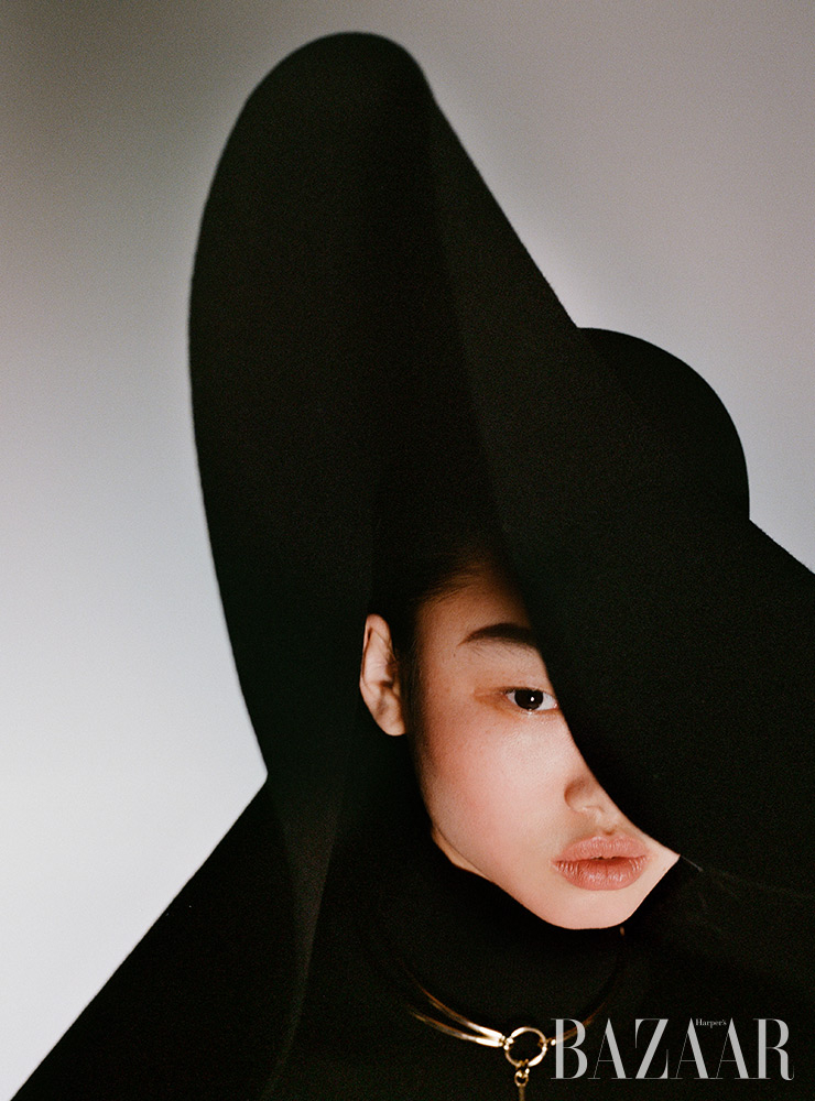 터틀넥 톱, 오버사이즈 모자, 목걸이는 모두 Givenchy.