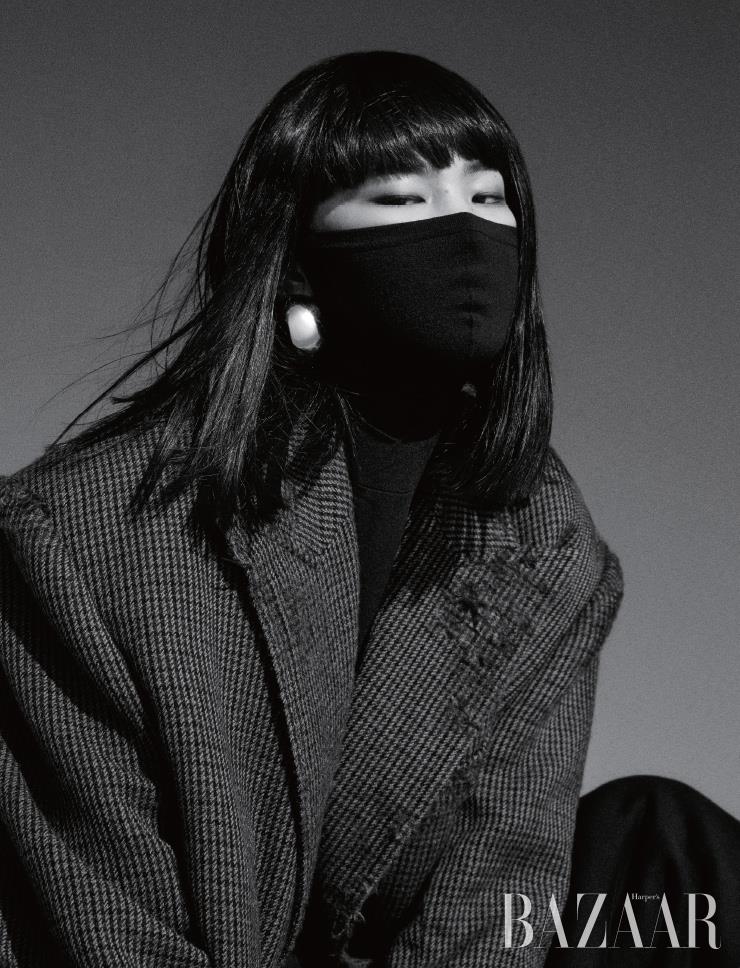 디스트로이드 코트, 마스크 터틀넥 톱, 스웨트팬츠, 귀고리는 모두 Balenciaga.