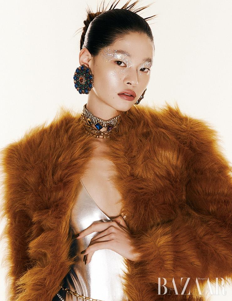 퍼 재킷, 보디수트, 귀고리, 레이어드한 초커, 벨트는 모두 Saint Laurent by Anthony Vaccarello.