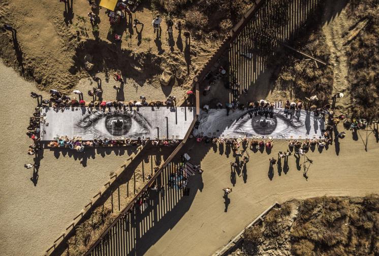 Migrants, Mayra, Picnic across the Border, Tecate, Mexico-U.S.A, Installation image, Wheat-pasted poster on table, 2017. ⓒ JR-ART.NET