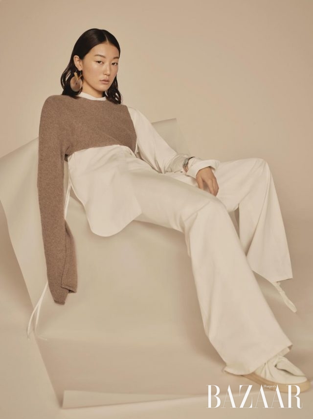 담백한 컬러 플레이에는 허리선을 강조할 것.비대칭적인 롱 슬리브 니트, 구조적인 디자인의 화이트 셔츠, 와이드 팬츠, 가죽 소재 슬립온은 모두 Ports 1961, 싱글 귀고리는 1백만원대로 Louis Vuitton, 뱅글은 Hermès 제품.