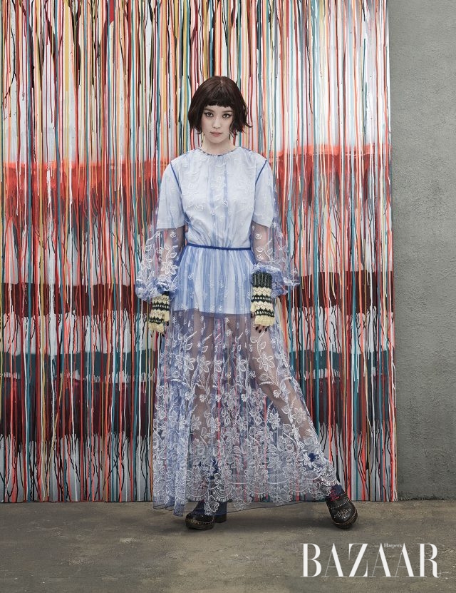 벌룬 소매 디테일의 엠브로이더리 장식 시스루 드레스, 이너로 입은 톱, 레트로 무드의 니트 장갑, 니트 양말, 프린지와 스터드 장식의 앵클부츠는 모두 Burberry 제품.