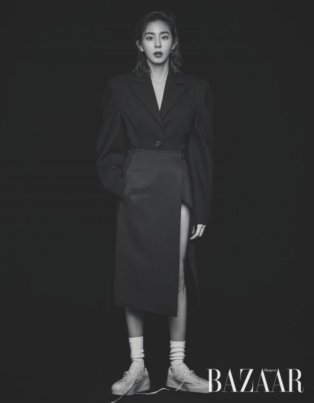 오버피트 파워 숄더 실루엣의 보디수트 재킷은 YCH, 레이어드한 랩 스커트는 H&M, 원형 디자인 귀고리는 Get Me Bling, 스니커즈는 Converse 제품.