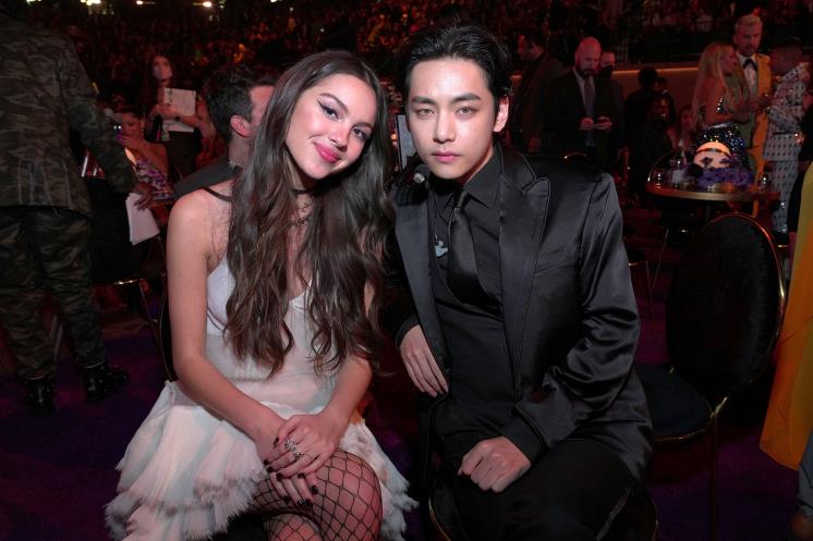 Olivia Rodrigo and V of BTS . Photo by Kevin Mazur/Getty Images for The Recording Academy