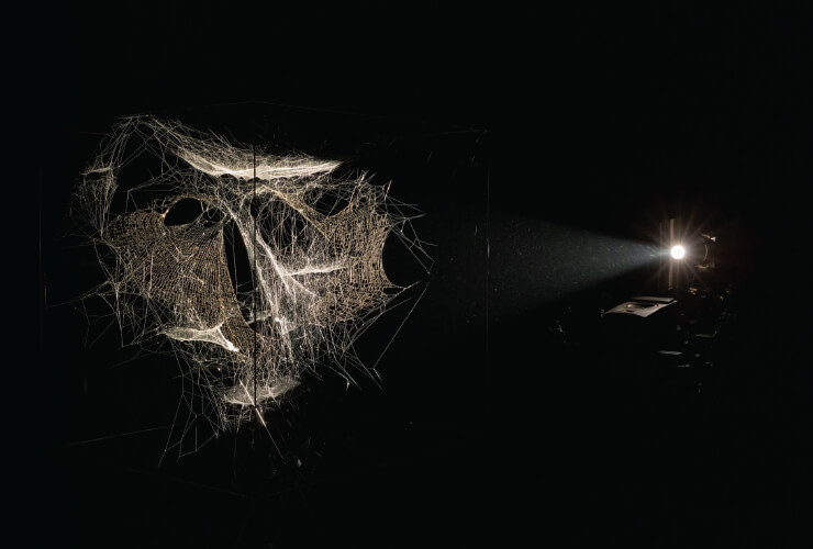 ‘Particular Matter(s): Jam Session’, 2018 Nephila senegalensis and Cyrtophora citricola silk. Carbon frame. Lightbeam, cosmic dust. Terrestrial dust. Stellar wind. Sonic waves. Video camera. Loudspeakers, video projector Courtesy of the artist and Esther Schipper, Berlin. © Photography by Studio Toma´s Saraceno, 2018