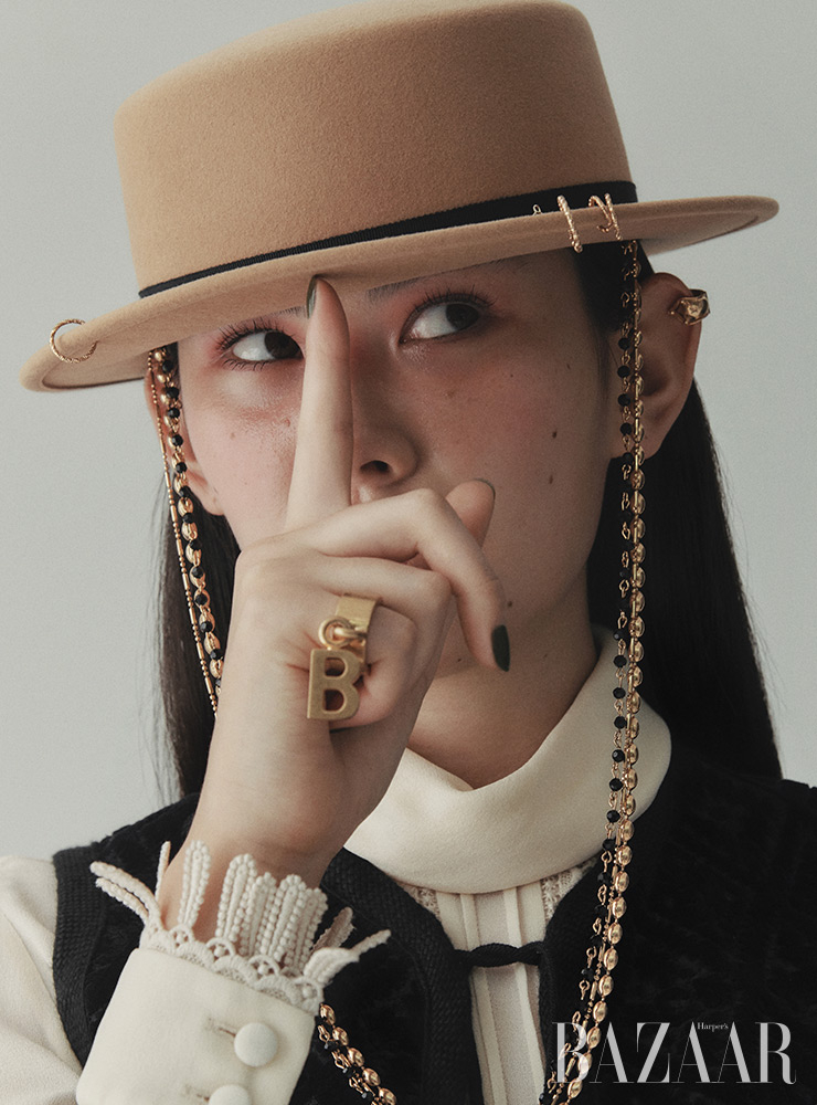 보터 해트는 Maison Michel by BOONTHESHOP. 이어커프는 Louis Vuitton. 반지는 Balenciaga. 블라우스, 베스트는 Celine.